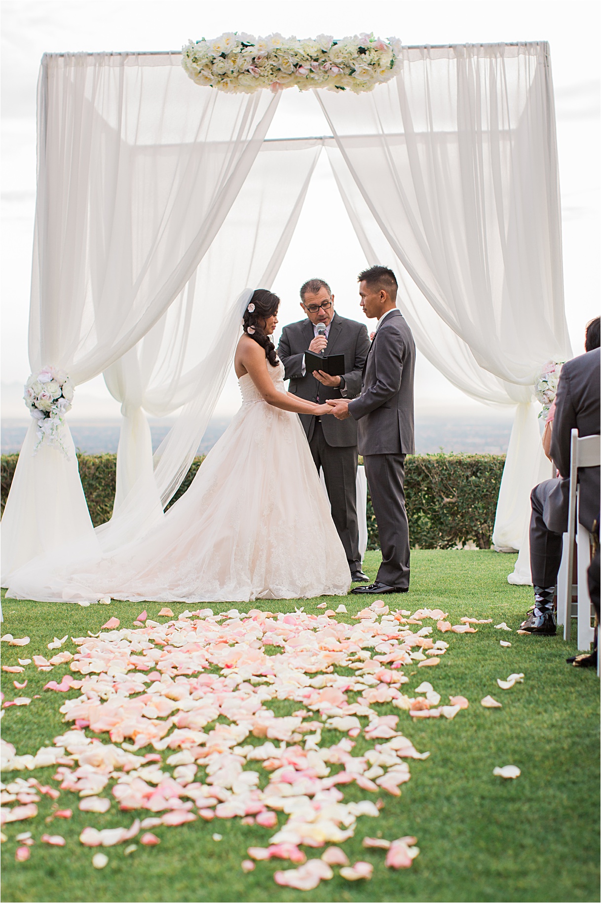 Ceremony with pink rose petals covering the aisle.